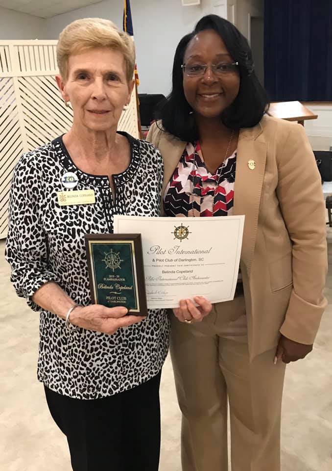 Belinda Copeland receives an award from Capt. Kim Nelson